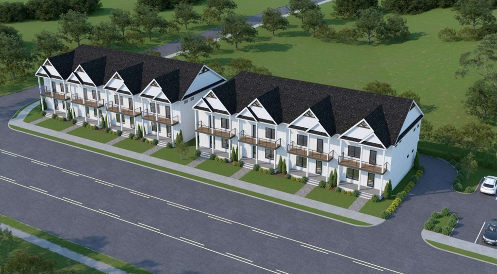 A row of houses with a white van parked in front.