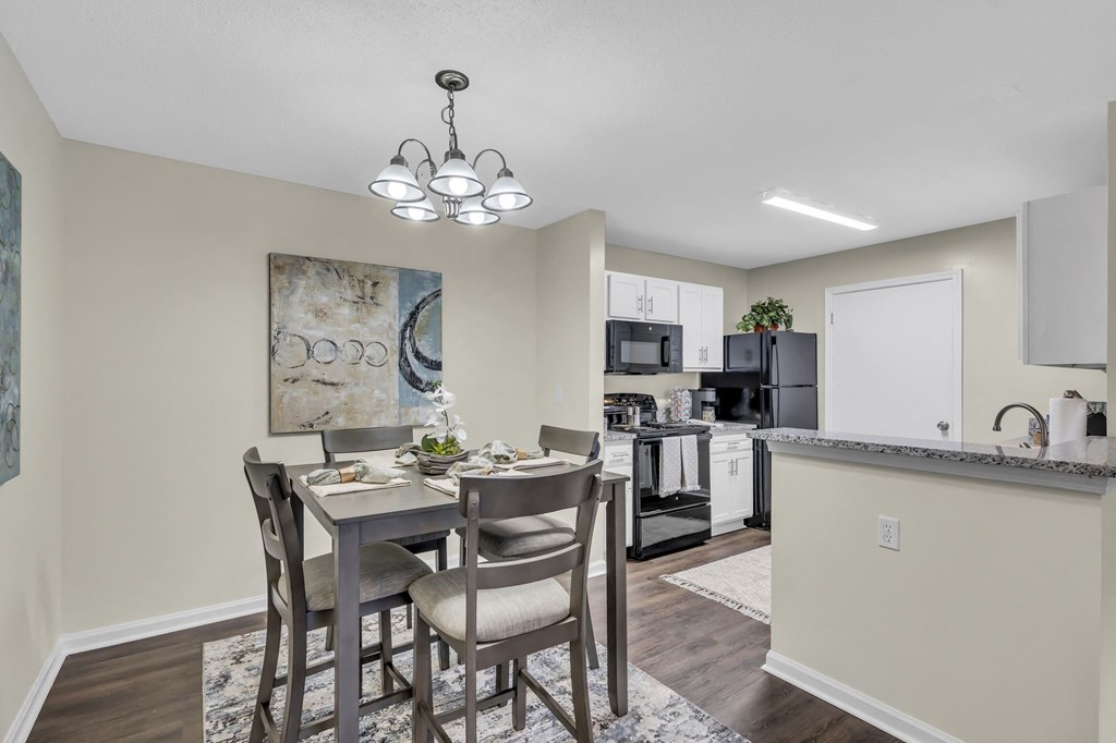 an open kitchen and dining room with a table and chairs