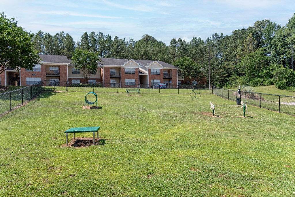 a park with a playground and buildings in the background