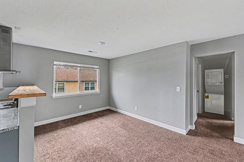 A room with a window and a door leading to another room.
