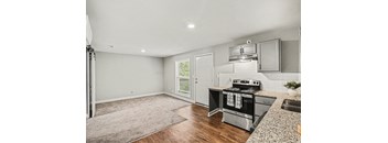 A kitchen with a stove top oven and a sink.