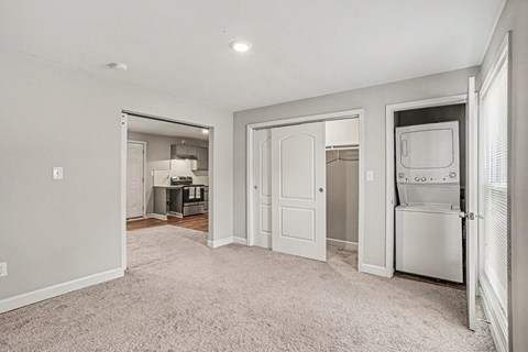 A white kitchen with a fridge, oven, and microwave.