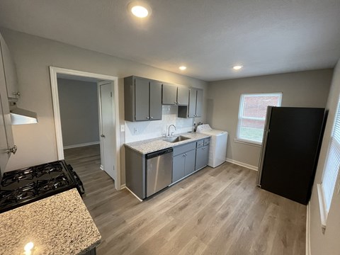 a kitchen with stainless steel appliances and white cabinets