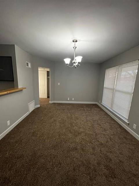 a living room with a carpet and a tv
