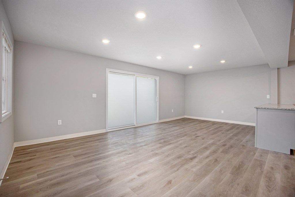 A room with wooden flooring and a bar counter.at Palisades Apartments, Kansas City Missouri