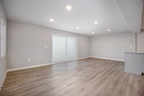 A room with wooden flooring and a bar counter.at Palisades Apartments, Kansas City Missouri