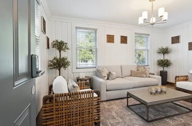 A living room with a couch, a chair, and a coffee table.