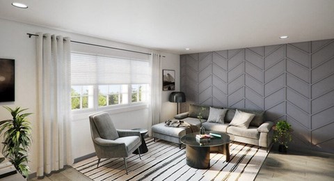 A modern living room with a grey sofa, a grey armchair, a coffee table, and a plant.