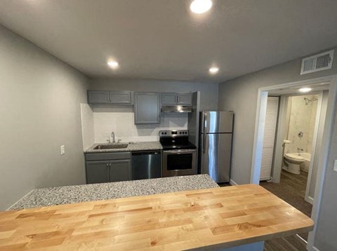 a kitchen with a wooden table and a refrigerator