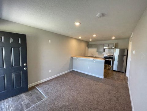 a living room view with a kitchen