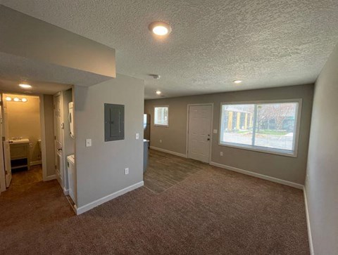an empty living room with a large window