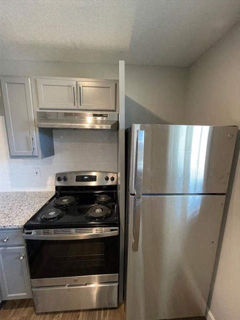 a kitchen with a stove and a refrigerator