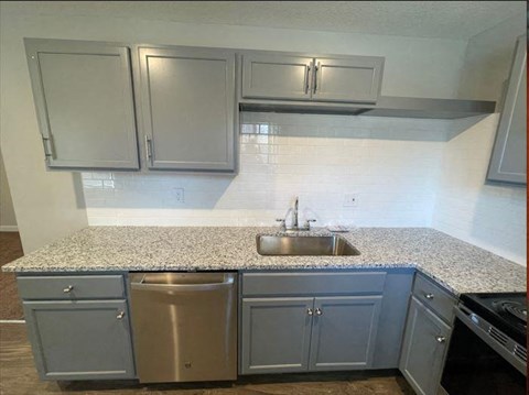 a kitchen with granite countertops and a sink