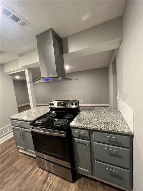a kitchen with stainless steel appliances and granite countertops