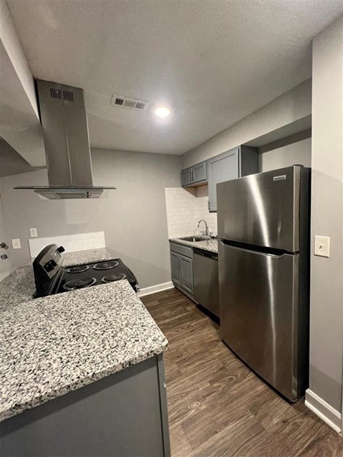 a kitchen with a stainless steel refrigerator and a counter top