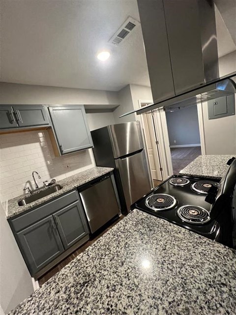 a kitchen with stainless steel appliances and granite counter tops