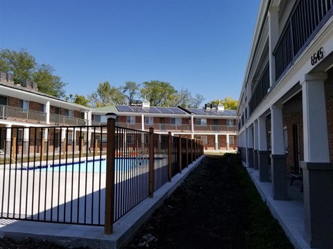 a view of a pool in a building with a fence