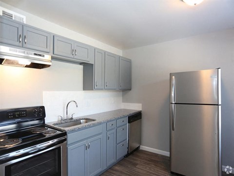 a kitchen with stainless steel appliances and white cabinets