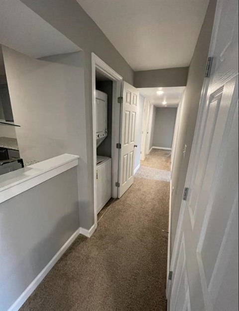 a hallway with a hall way and a door to a closet