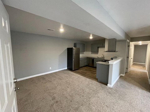 an empty living room and kitchen in a house