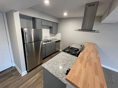 a kitchen with stainless steel appliances and a wooden counter top