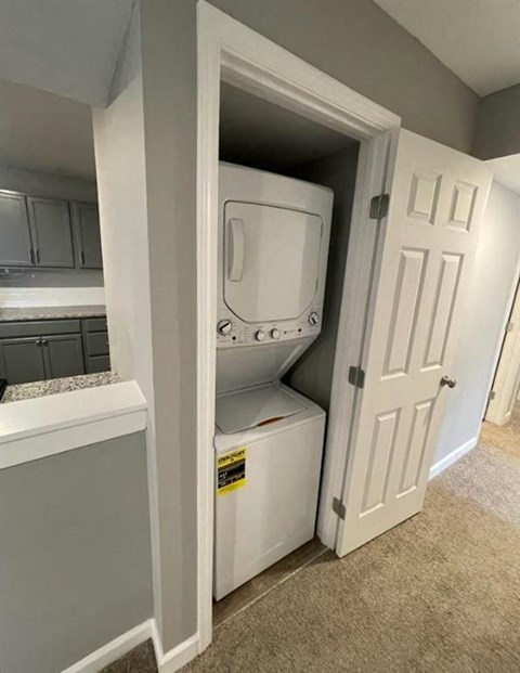 a bathroom with a washer and dryer in a closet