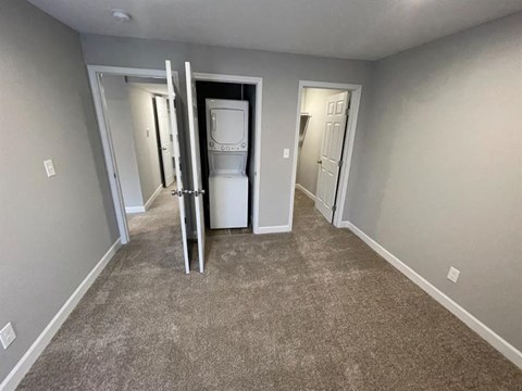 a hallway with a closet and a toilet in a room