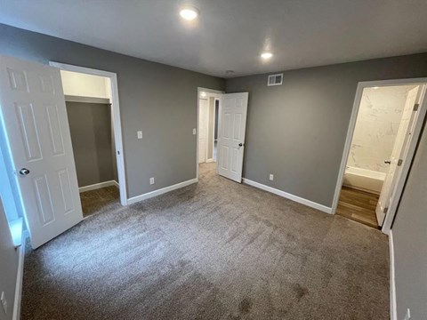 master bedroom with a closet and bathroom