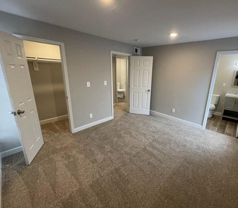 a room with a carpeted floor and a white door