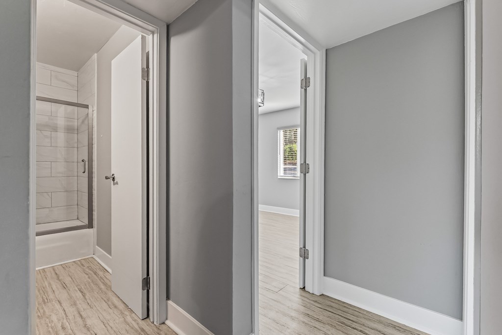 A white door is open to a bathroom.