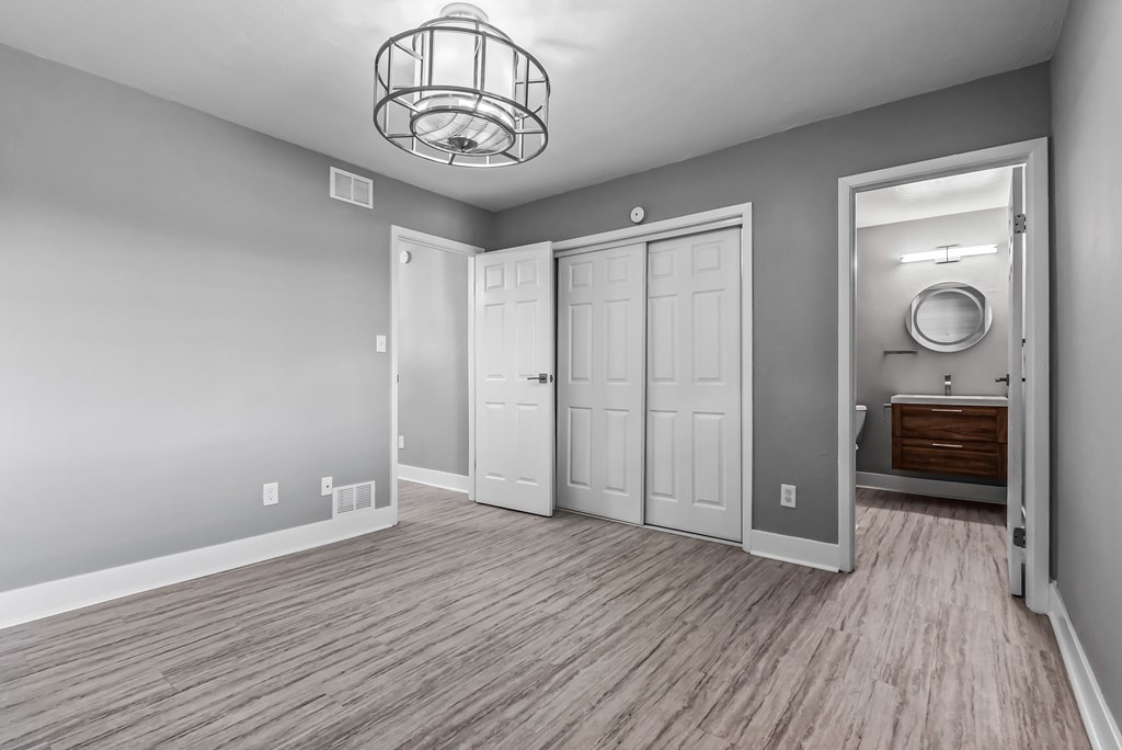 A room with a wooden floor and a chandelier.