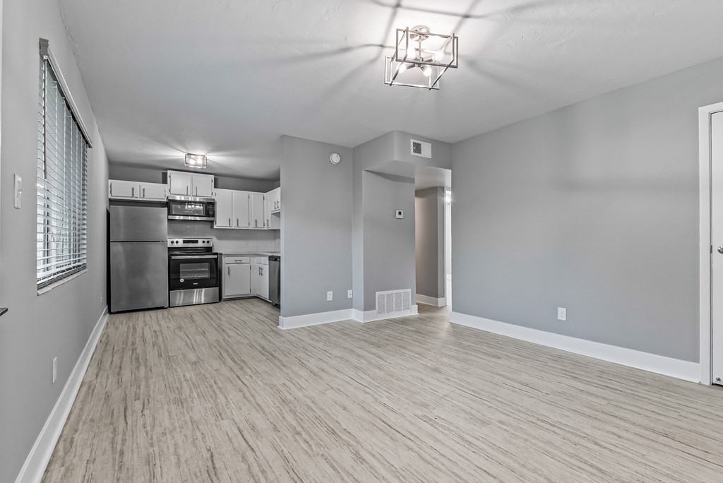 A spacious kitchen with wood flooring and a large island.