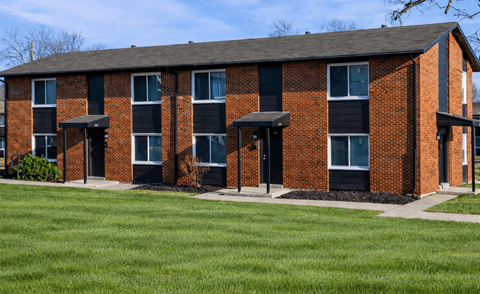 A red brick building with black trim and windows.