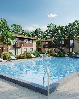 A swimming pool in front of apartment buildings.