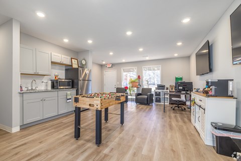 A kitchen with a table and chairs in the middle of the room.