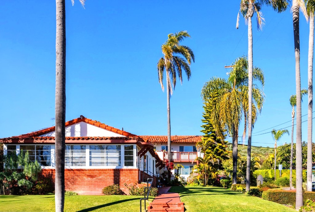 an apartment building with palm trees