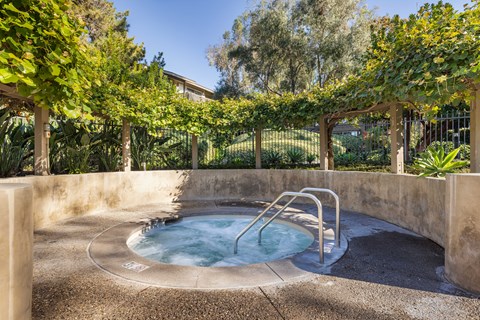 A hot tub sits in the middle of a garden at The Aspens Fairhaven, Santa Ana, 92705