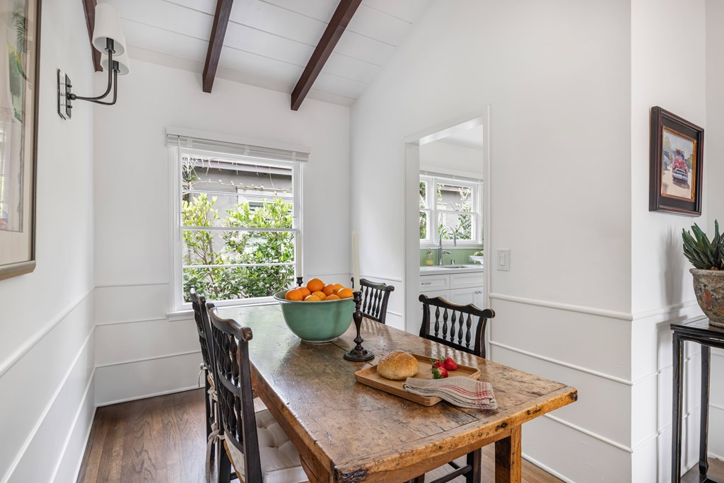 A dining room with a wooden table and chairs.