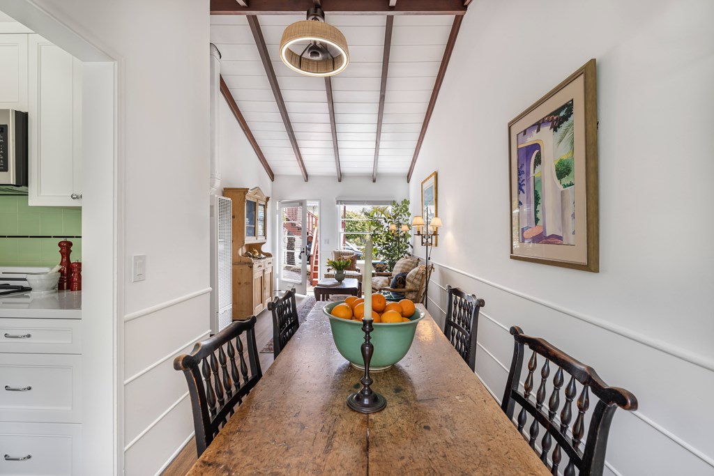 A kitchen with a long wooden table and chairs.