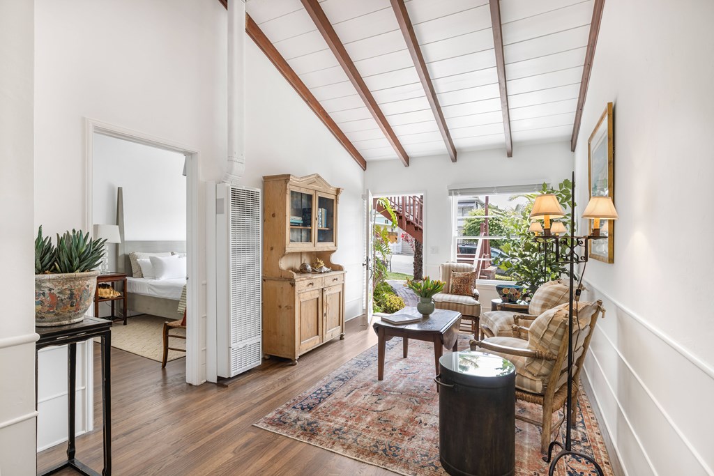 A living room with a wooden floor and white walls.