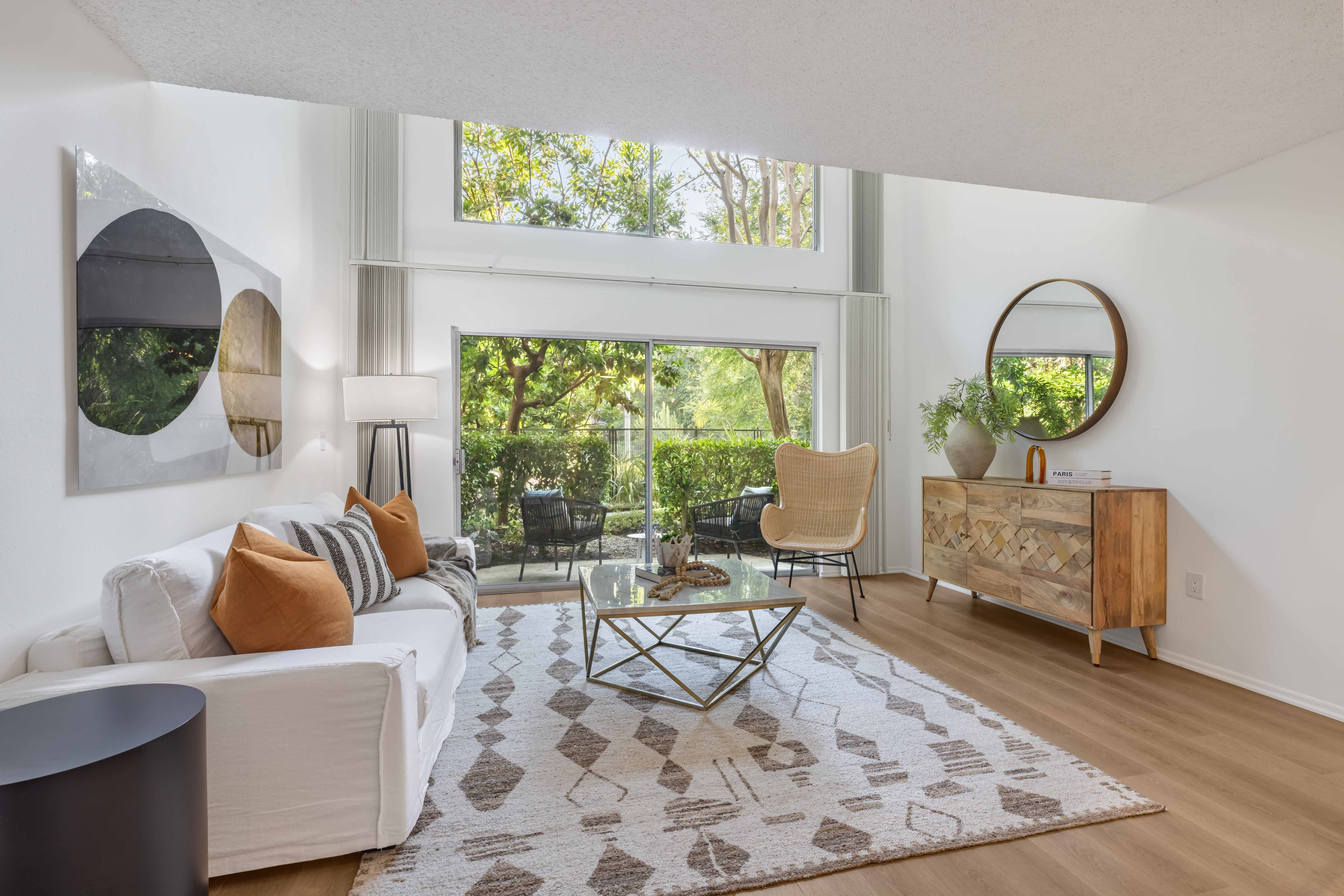 a living room with a white couch and a large window
