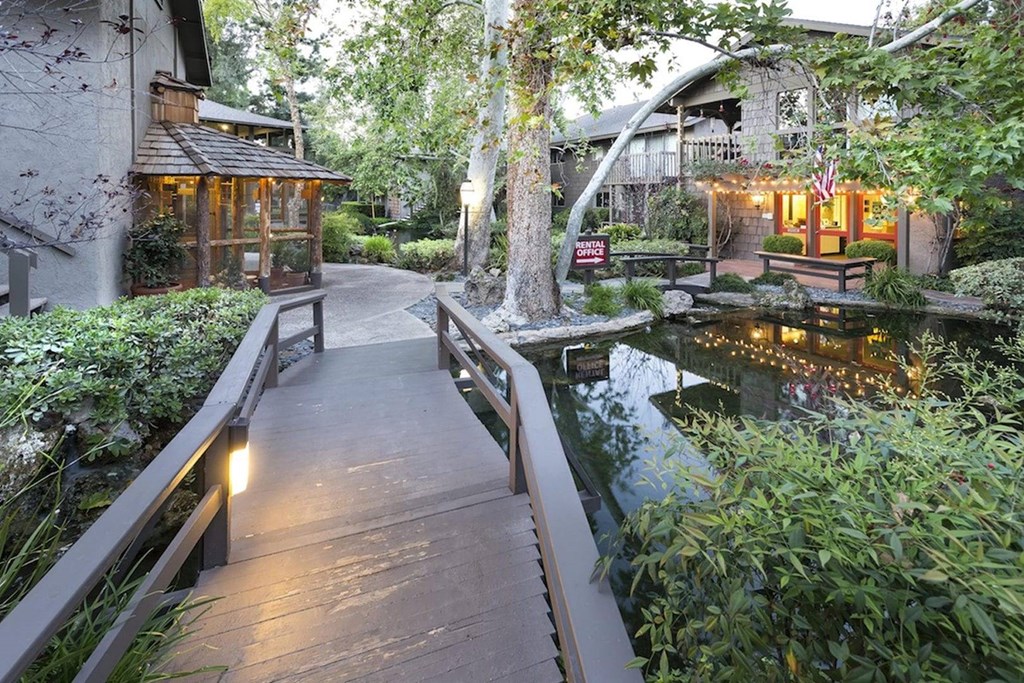 a wooden bridge over a pond in a garden at The Aspens Riverside, California, 92504
