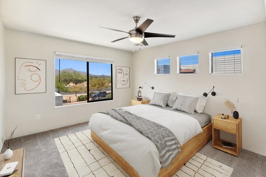 the master bedroom has a large bed and a ceiling fan at Galeria Del Rio, Tucson, AZ