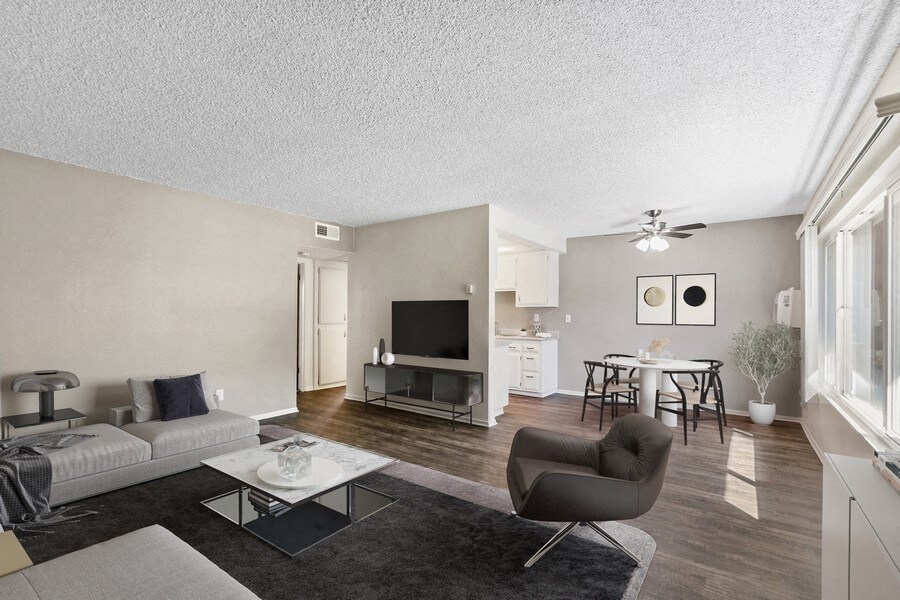 the living room of an apartment with a couch and a chair