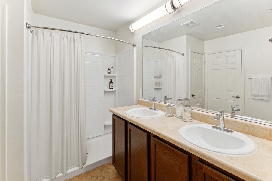 a bathroom with two sinks and a shower and a curtain at Galeria Del Rio, Arizona, 85704