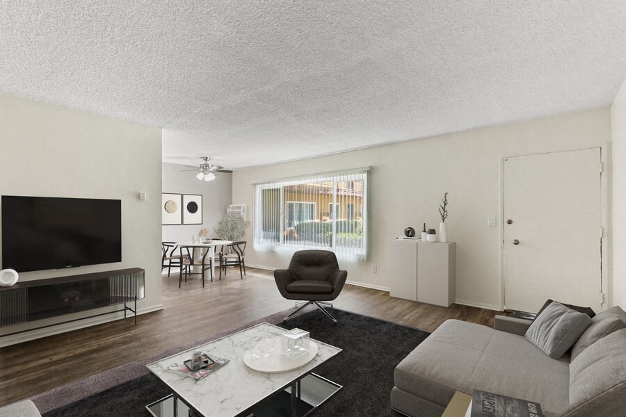 the living room of an apartment with a couch and a tv