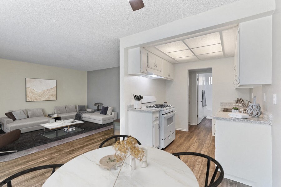 an open living room and kitchen with a table and chairs