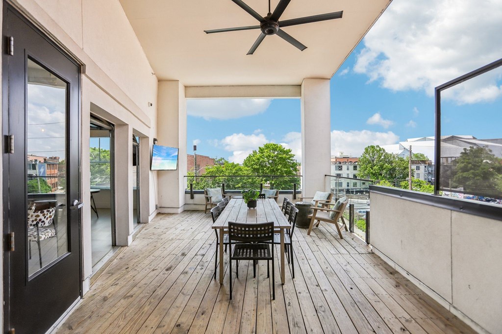 A patio with a table and chairs overlooking a cityscape.