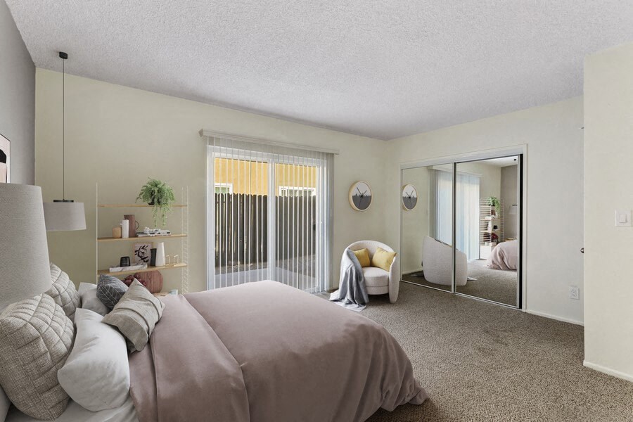 a bedroom with a large bed and a mirror