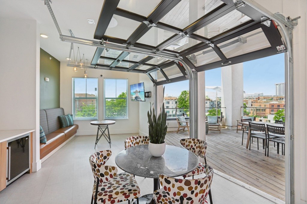 A modern dining room with a glass table and chairs.